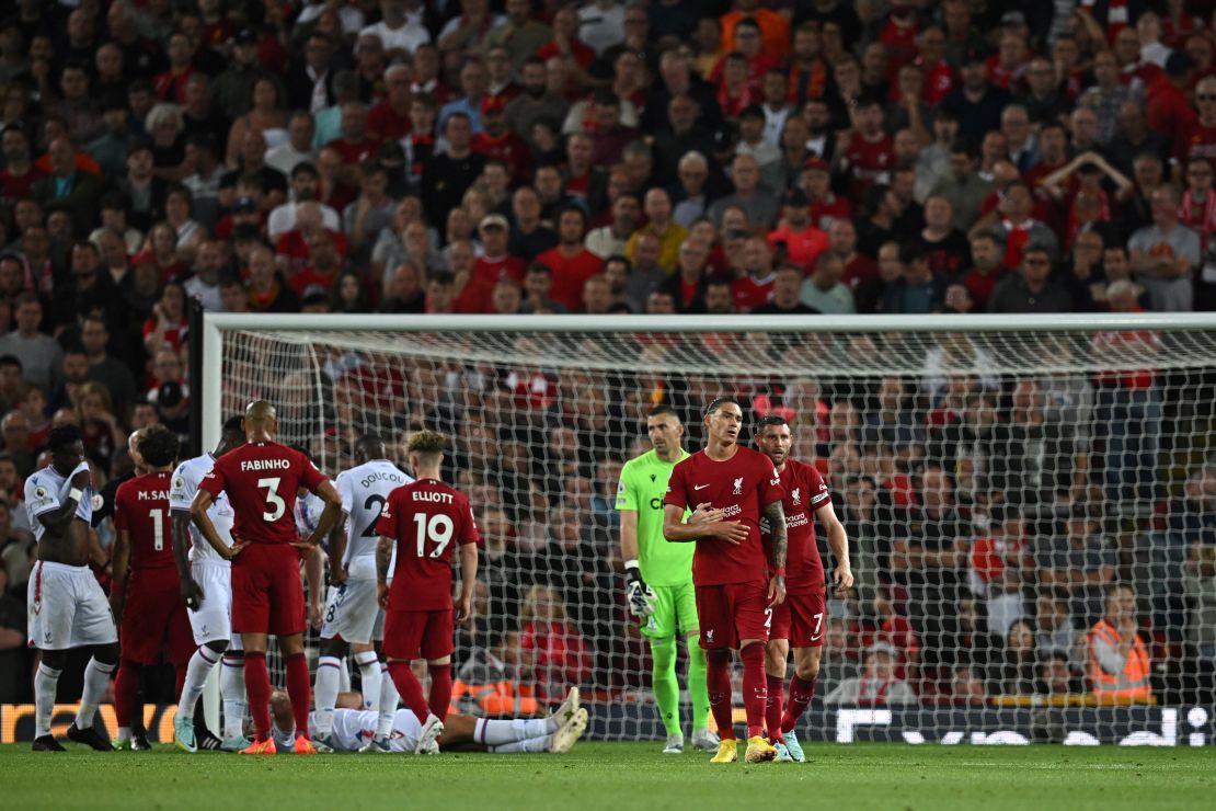 James Milner ushers Núñez off the pitch after he was shown a red card. 