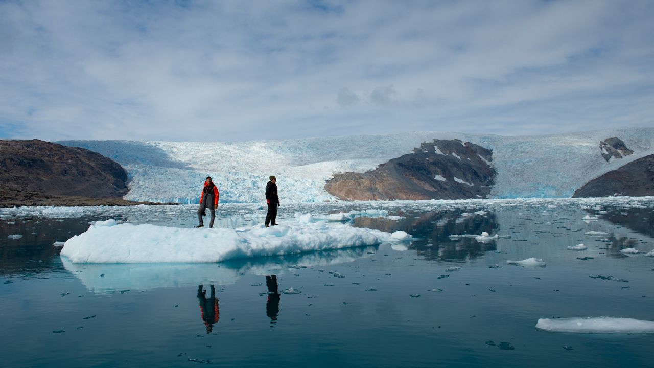 David Gruber (left) and John Sparks (right) investigate an iceberg in eastern Greenland.
