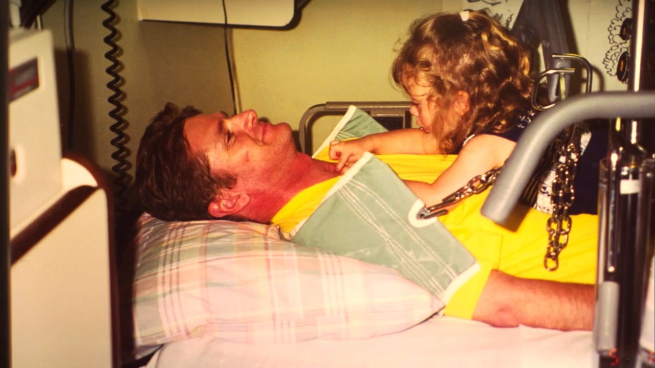 Schmidt's daughter visits him in hospital following his crash.