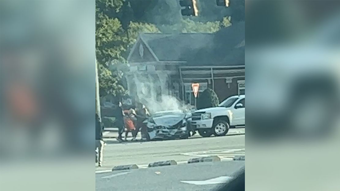 The group of teenagers worked quickly to free the woman trapped in her car.