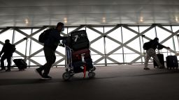 Travelers walk with their luggage at San Francisco International Airport on July 01, 2022 in San Francisco, California. 