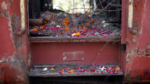 Flower petals scattered by victims' relatives at the doors of a train carriage that was set on fire in 2002, on the anniversary of riots at Godhra in Gujarat, India on February 27, 2014. 