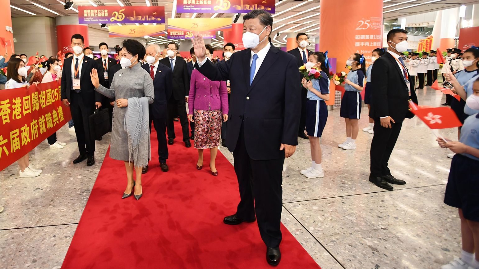 Chinese leader Xi Jinping and his wife Peng Liyuan were greeted by school children on their arrival to Hong Kong on June 30, 2022.
