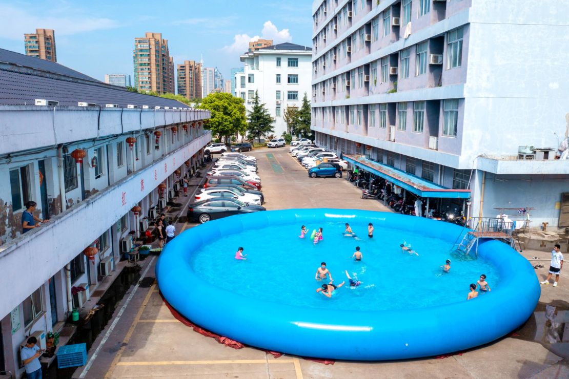 Children beat the heat at a gated community in Huzhou City in China's Zhejiang Province on August 12, 2022.