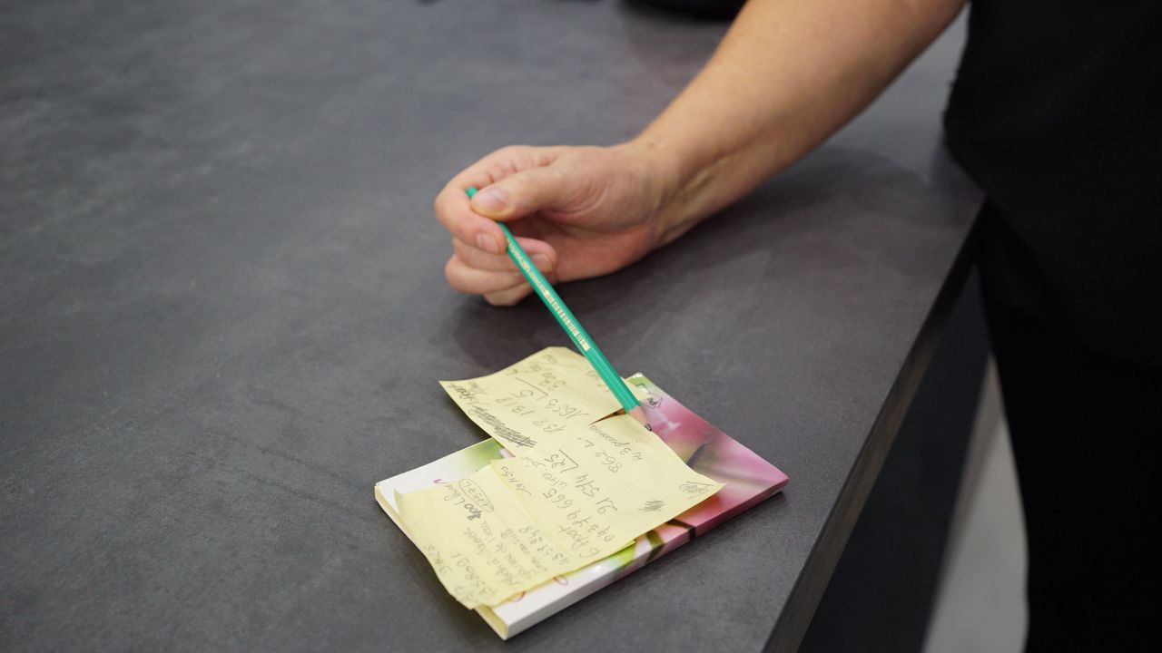 Brigitte Ricou tallies water consumption in her home after taking readings from her meter.