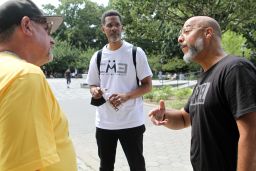 Clinton Lacy listens to Bishop David Maldonado and Antonio Fernandez at Maria Hernandez Park, in Bushwick, Brooklyn, on July 31, 2022.
