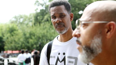 Clinton Lacy listens to Bishop David Maldonado at Maria Hernandez Park, in Bushwick, Brooklyn, on July 31, 2022.