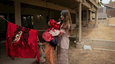 Sahar Ibrahami, 13, takes down laundry outside the basement apartment where part of her family has been staying in Modesto, California. Her family was separated when they fled Afghanistan.