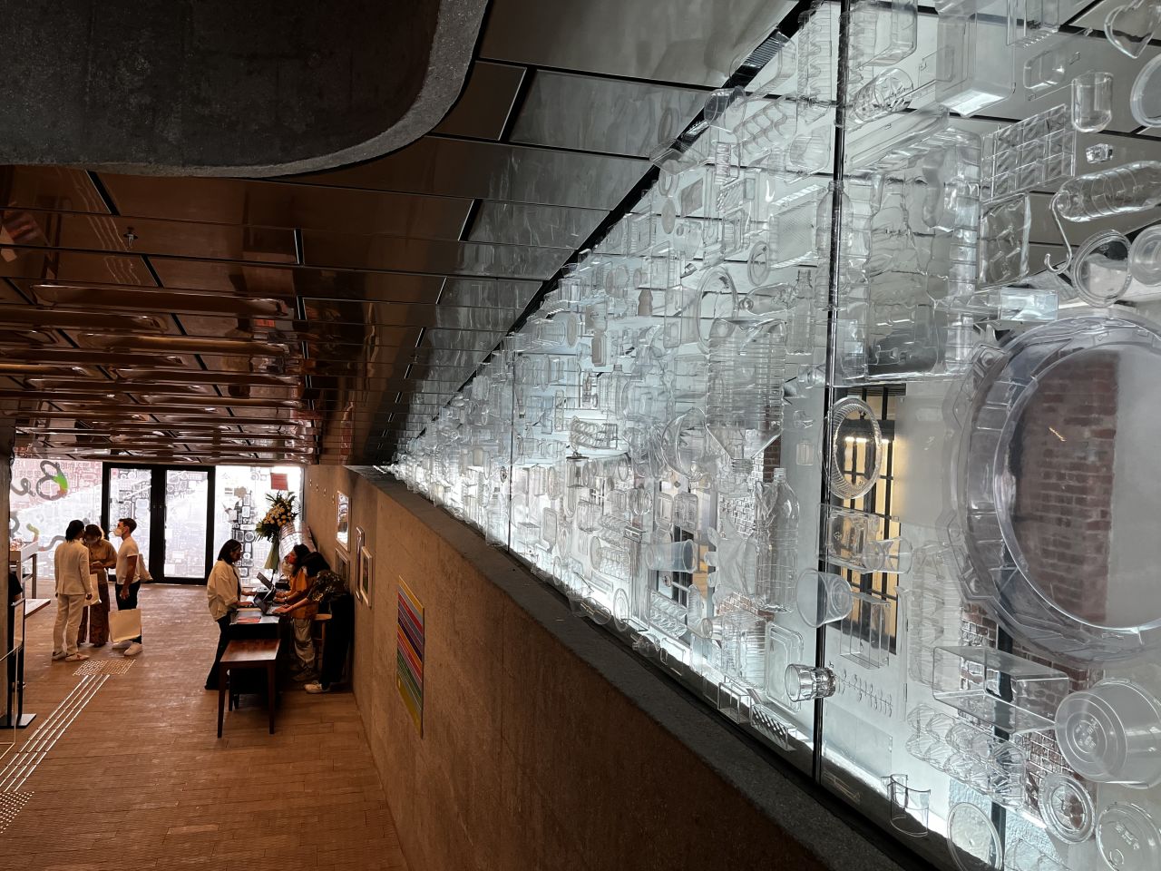 In the lobby, "The Innocent Collection" uses plastic bottles (which Rist calls "instant diamonds") to decorate the entrance doors and windows, questioning perceptions of waste and environmental issues. 