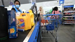 A cashier scans items at a Walmart store in Burbank, California on August 15, 2022. - Walmart, the largest retailer the United States, will report second quarter earnings on August 16, 2022. (Photo by Robyn Beck / AFP) (Photo by ROBYN BECK/AFP via Getty Images)