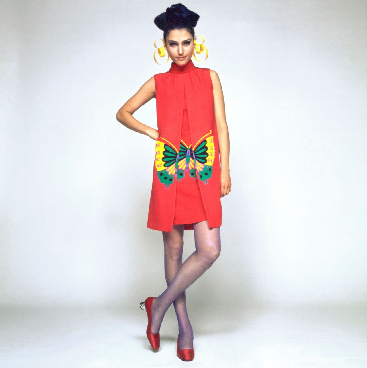 Model Benedetta Barzini wearing a Hanae Mori sleeveless dress printed with a yellow-and-green butterfly, one of the designer's signature motifs.