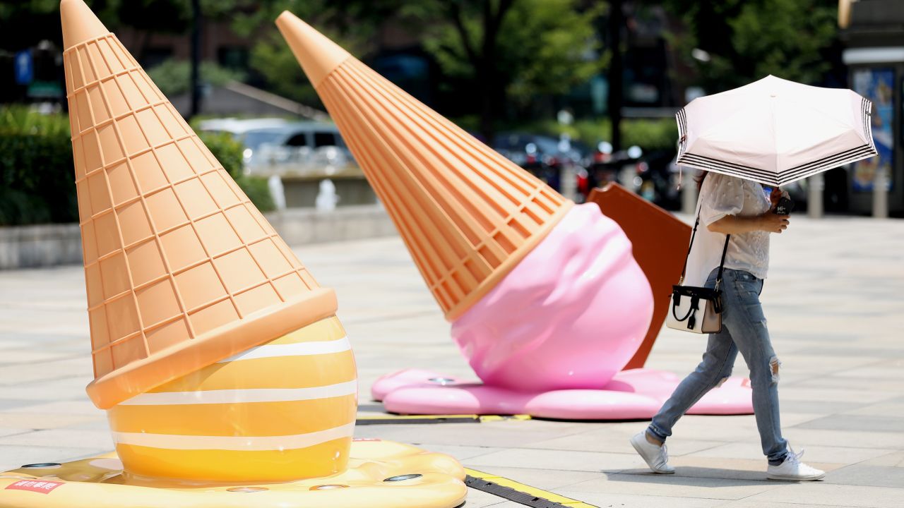 A citizen walks by ice cream-shaped installations outside a shopping mall amid a heat wave on August 2, 2022 in Hangzhou, Zhejiang Province of China.