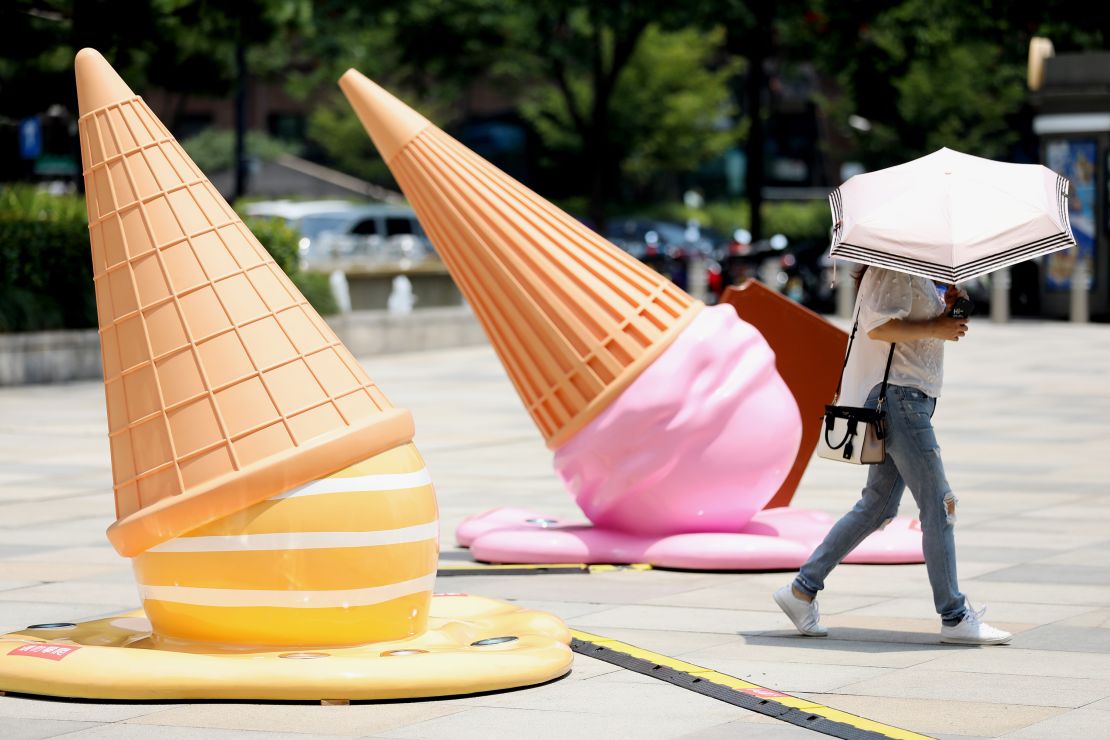 A citizen walks by ice cream-shaped installations outside a shopping mall amid a heat wave on August 2, 2022 in Hangzhou, Zhejiang Province of China.