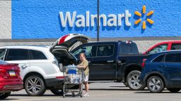 A woman loads groceries into her car at a Walmart Supercenter.