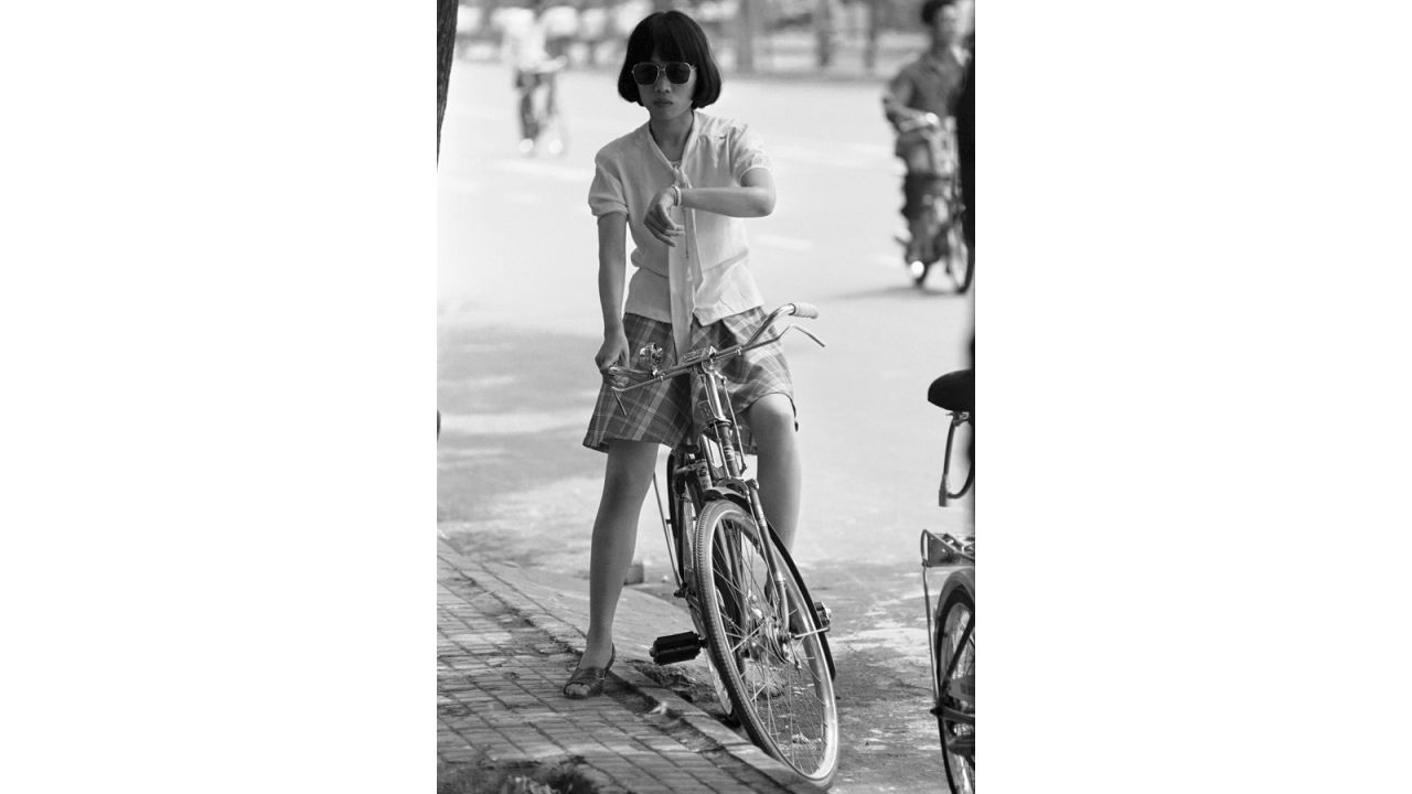 <strong>Before smartphones: </strong>A woman pauses to check her wrist watch while riding through Beijing in 1981. 