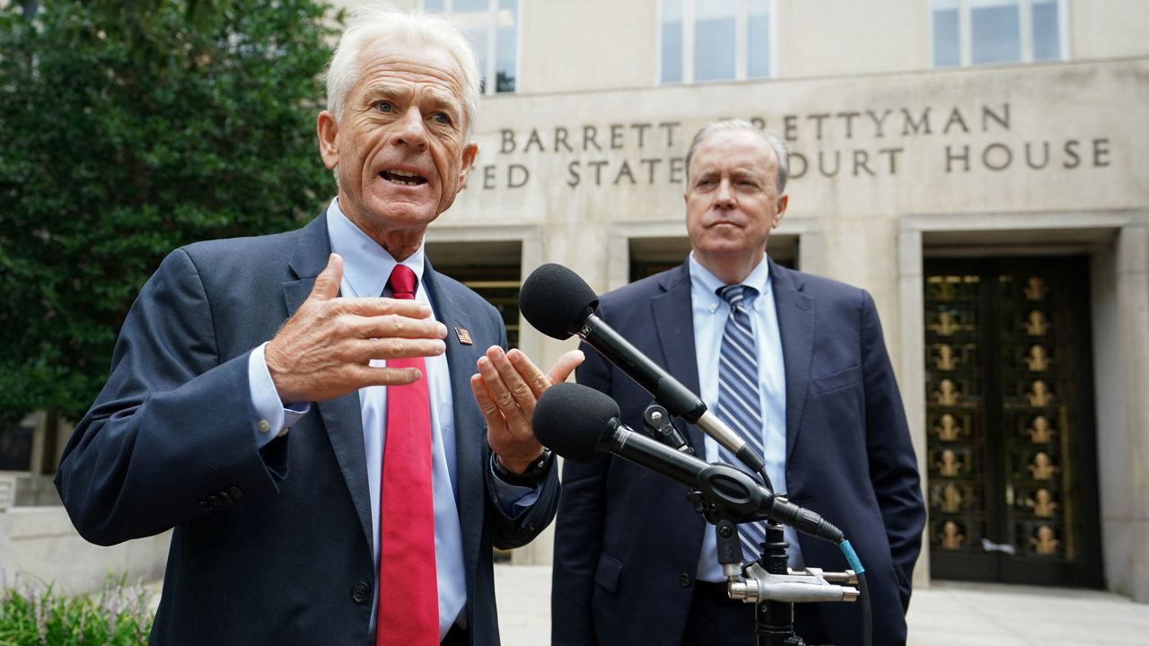 Peter Navarro, adviser to former US President Donald Trump, with his lawyer John Rowley at his side, speaks to reporters at the US District Court in Washington, on August 11, 2022. 