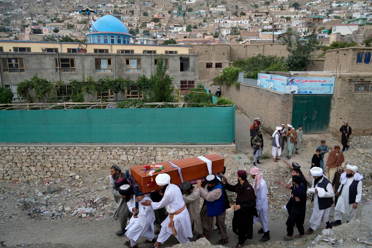 Mourners carry the casket of a victim of <a href="https://www.cnn.com/2022/08/17/middleeast/kabul-mosque-explosion-afghanistan-intl/index.html" target="_blank">a mosque bombing</a> in Kabul, Afghanistan, on Thursday, August 18. The explosion erupted during evening prayer on Wednesday, killing 21 people and injuring 33 others, according to a spokesperson for the Kabul police chief.