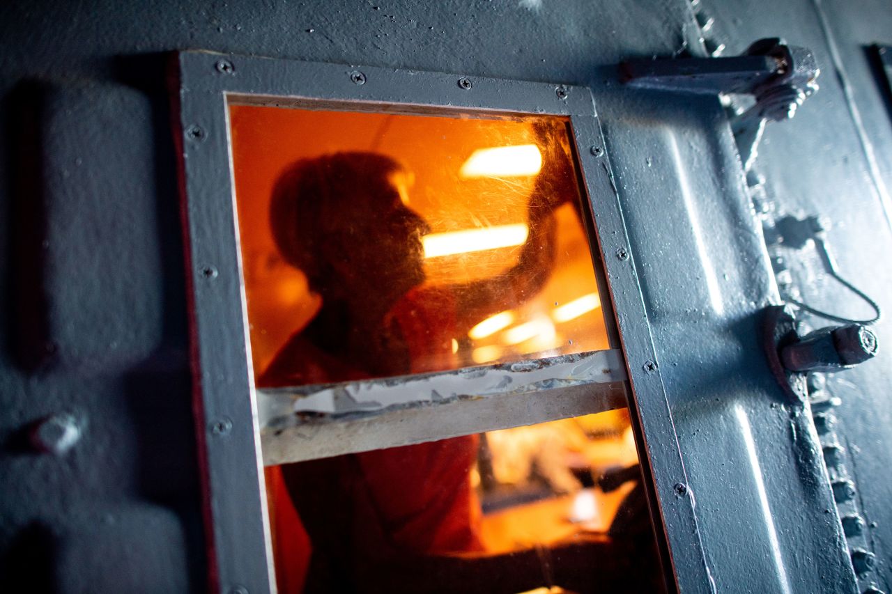 A visitor at the Wilhelmshaven Naval Museum attempts to get out of an escape room in Wilhelmshaven, Germany, on Friday, August 12. The museum offers the "Escape Game" in a former ship, where museum visitors are voluntarily locked in a room and try to solve a series of puzzles together in order to break free.