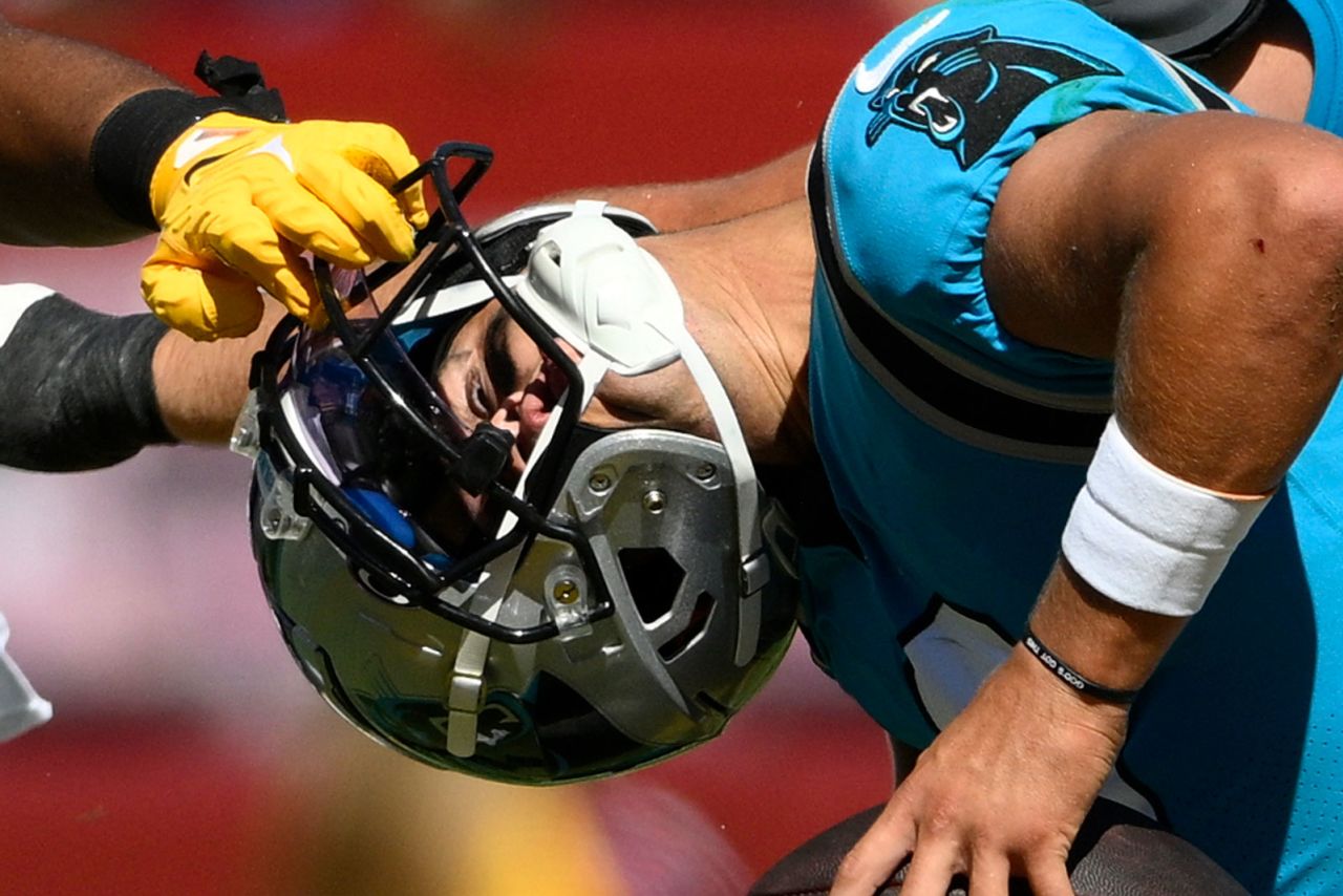 Washington defensive end Shaka Toney grabs the facemask of Carolina quarterback Matt Corral during the second half of a preseason NFL game on Saturday, August 13. Carolina won 23-21.
