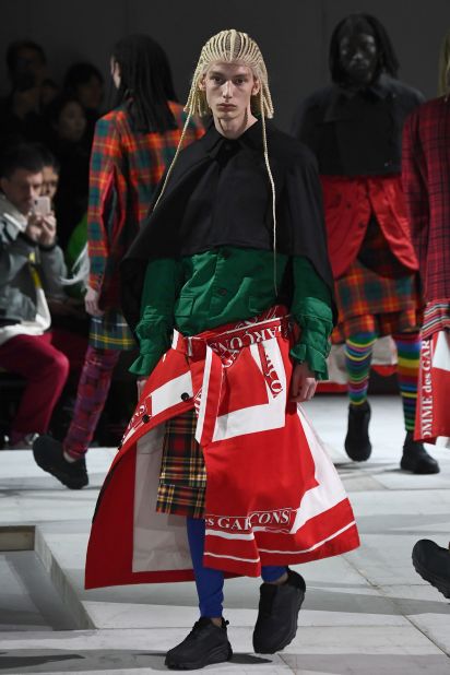 A male model wears a patterned skirt at Comme Des Garçons' Fall-Winter 2020/21 menswear show. Scroll through the gallery to see more male skirts, past and present.