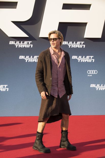 Brad Pitt attends a screening of "Bullet Train" wearing a brown linen skirt and blush pink top.