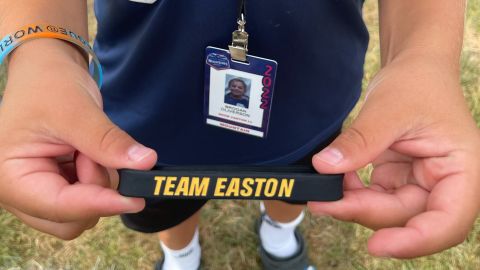 Brogan Oliverson shows off a bracelet in support of his older brother Easton.