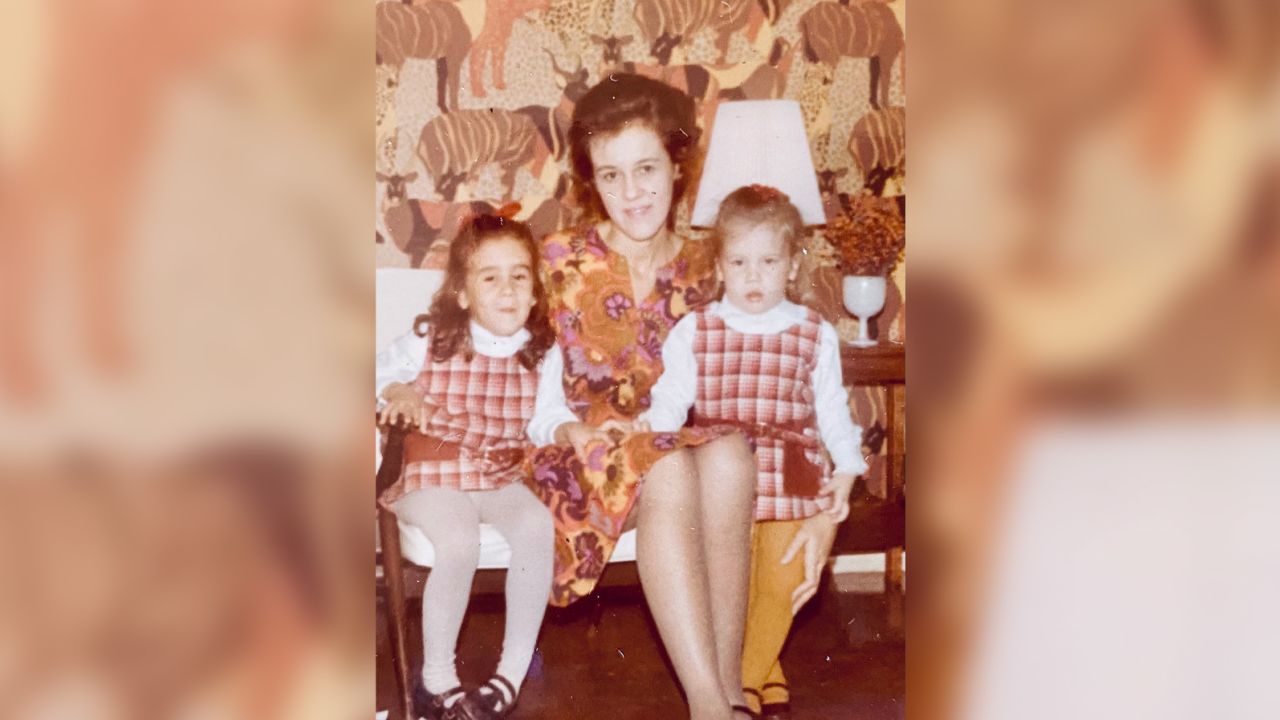 My mom poses with my sister (right) and me on Christmas eve, 1970.