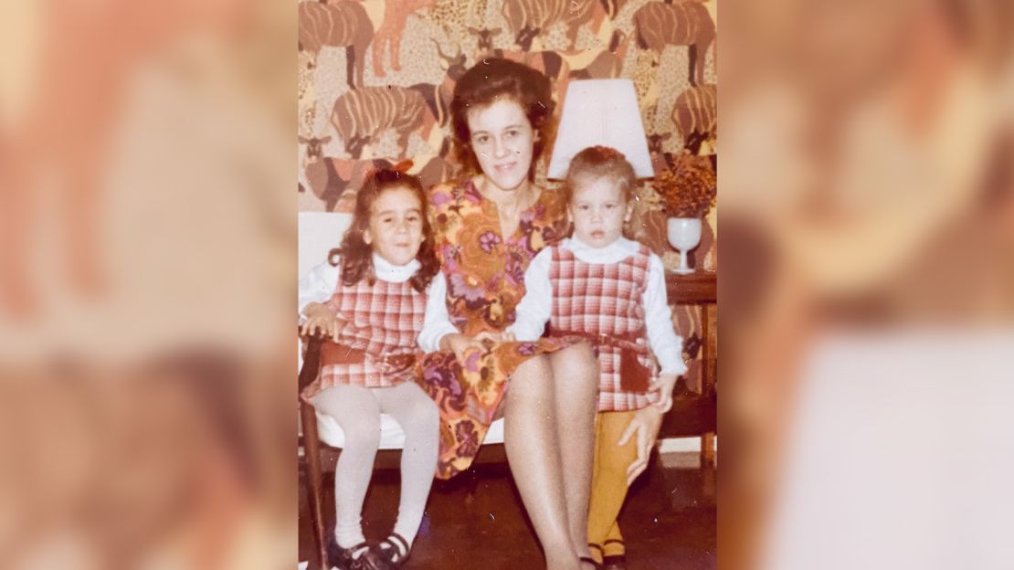 My mom poses with my sister (right) and me on Christmas eve, 1970.