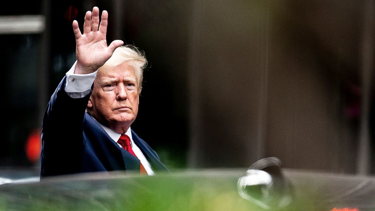 Former President Donald Trump waves as he departs Trump Tower on August 10, 2022, on his way to the New York attorney general's office for a deposition.