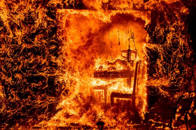 Flames engulf a chair inside a burning home in Mariposa County, California, on July 23. The <a href="index.php?page=&url=https%3A%2F%2Fwww.cnn.com%2F2022%2F07%2F27%2Fus%2Fgallery%2Foak-fire-california%2Findex.html" target="_blank">Oak Fire,</a> which started near Yosemite National Park, burned nearly 20,000 acres and is California's <a href="index.php?page=&url=https%3A%2F%2Fwww.cnn.com%2F2022%2F07%2F26%2Fus%2Fcalifornia-oak-fire-yosemite-mariposa-county-tuesday%2Findex.html" target="_blank">biggest wildfire</a> of the year. The challenging terrain and abundant dry vegetation fueling the wildfire complicated efforts to tamp down its growth, a Cal Fire spokesperson told CNN.