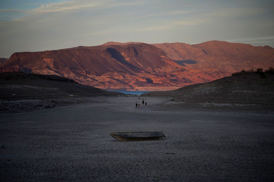 A formerly sunken boat sits on cracked earth hundreds of feet from what is now the shoreline on Lake Mead near Boulder City, Nevada, on May 9. According to a new projection from the Department of the Interior, Lake Mead's water level will be below 1,050 feet above sea level in January -- the threshold required to declare a <a href="https://www.cnn.com/2022/08/16/us/colorado-river-water-cuts-lake-mead-negotiations-climate/index.html" target="_blank">Tier 2 shortage</a> starting in 2023.