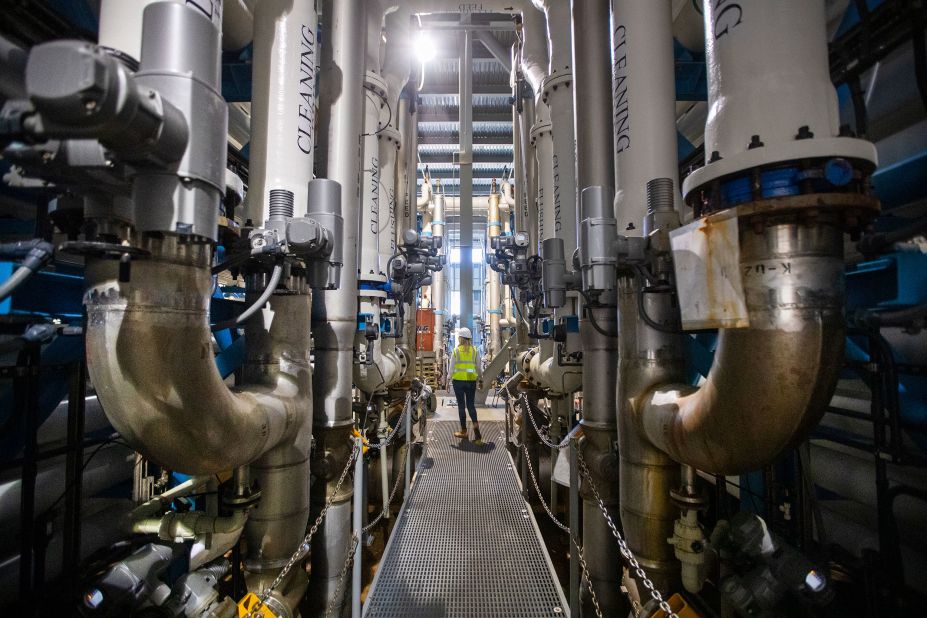 Michelle Peters, a technical and compliance manager for Poseidon Water, walks through the reverse osmosis building at the Claude Lewis Carlsbad Desalination Plant in Carlsbad, California, on March 30. The plant converts ocean water into municipal water. In August, Gov. Gavin Newsom laid out a <a href="