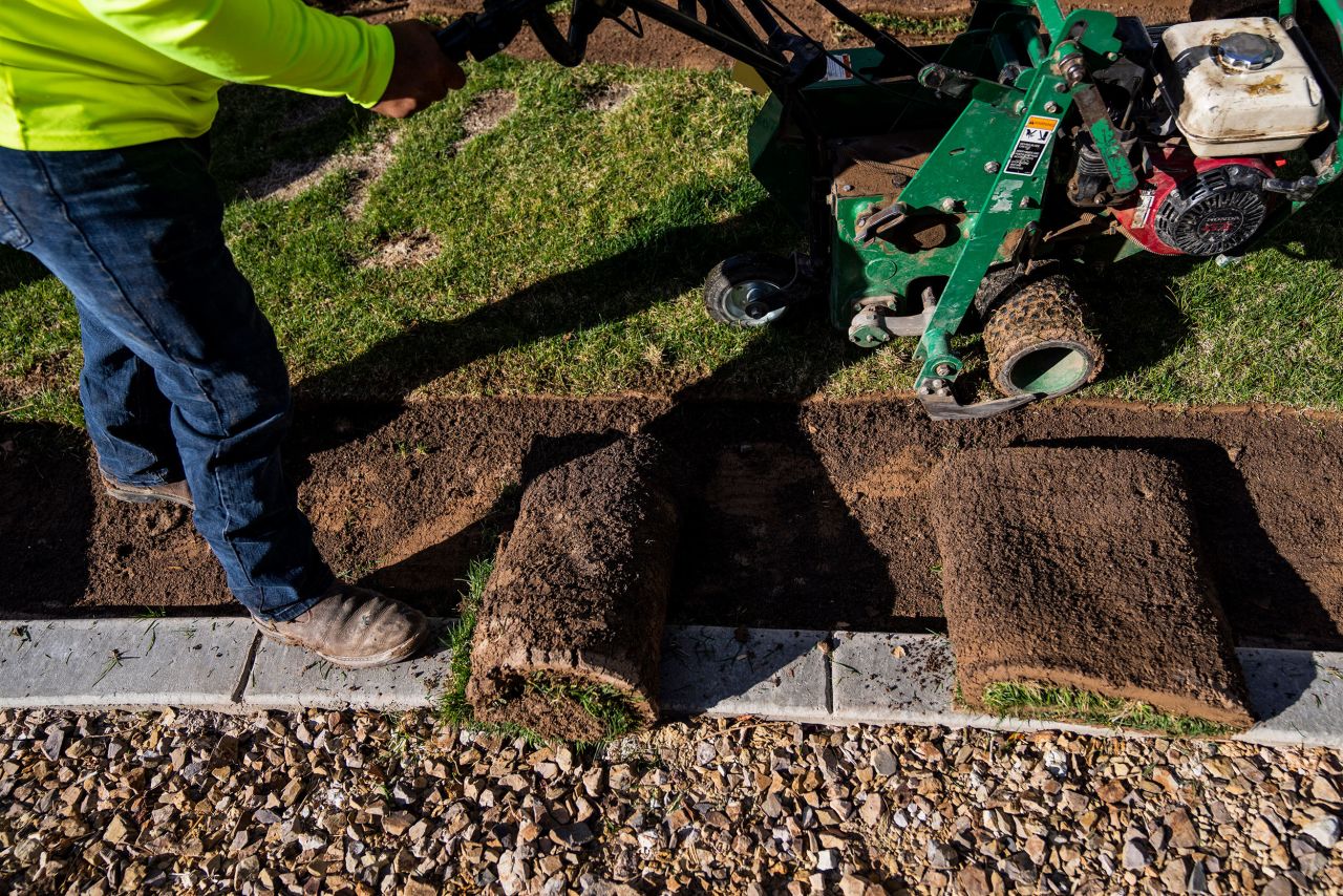 A landscaping crew removes non-functional turf from a residential development in Las Vegas on March 30. Under a Nevada state law passed last year, patches of non-functional grass that serve only for aesthetic purposes must be removed in favor of more desert-friendly landscaping.