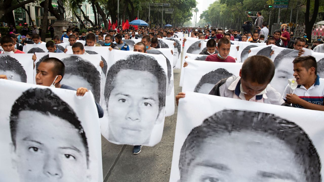 Students from the Raul Isidro Burgos rural teachers' college holding images of the 43 missing students on September 26, 2020. 