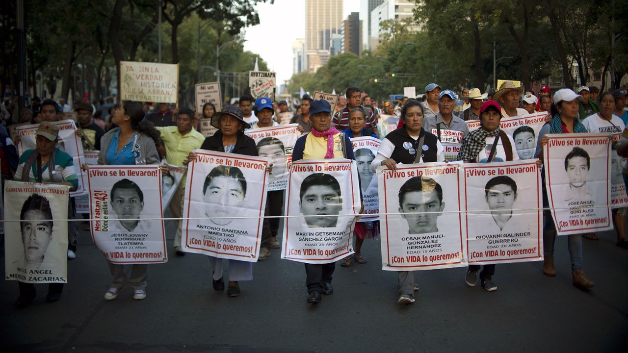 People march during a protest demanding justice in the case of the students of Ayotzinapa, in Mexico City on November 26, 2015. 