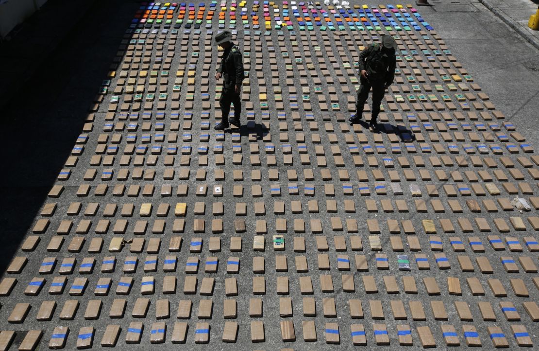 Police officers walk among packages of seized cocaine at the Pacific port of Buenaventura, Colombia.