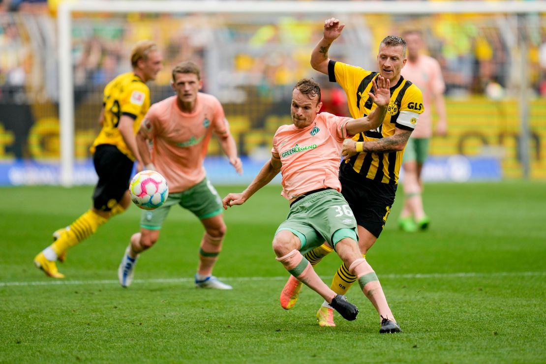 Christian Gross of Werder Bremen and Borussia Dortmund's Marco Reus in action during their Bundesliga match. 
