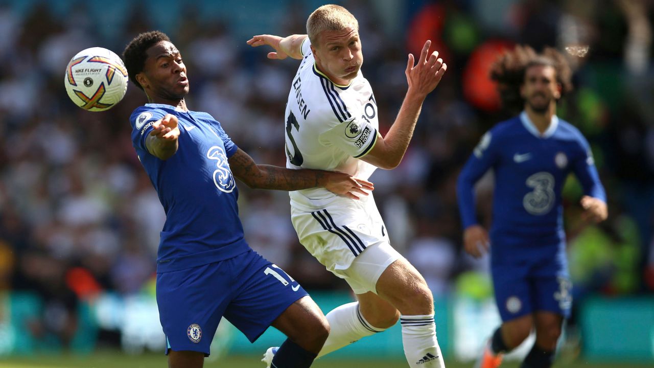 Chelsea's Raheem Sterling (left) Rasmus Kristensen of Leeds United (center) battle for the ball.