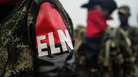 Members of the "Omar Gomez" Western War Front of the National Liberation Army (ELN) guerrilla line up in their camp on the banks of the San Juan River, Choco department, Colombia, on November 19, 2017.