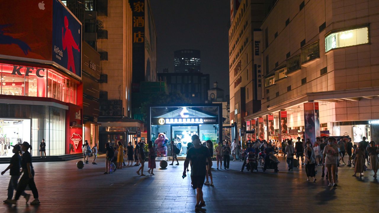People visit the Taikoo Li shopping complex as lights are partially turned off to conserve energy on August 18, 2022 in Chengdu, Sichuan Province of China.