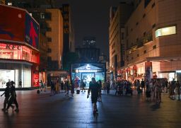 People visit the Taikoo Li shopping complex as lights are partially turned off to conserve energy on August 18, 2022 in Chengdu, Sichuan Province of China. 