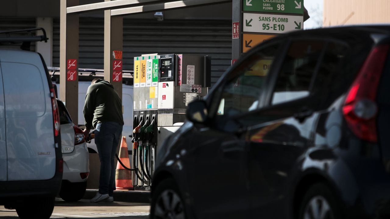 A customer refuels a vehicle at a TotalEnergies SE gas station in Toulouse, France, on Thursday, Feb. 10, 2022. TotalEnergies promised to increase its dividend and buy back more shares after posting a record fourth-quarter profit.