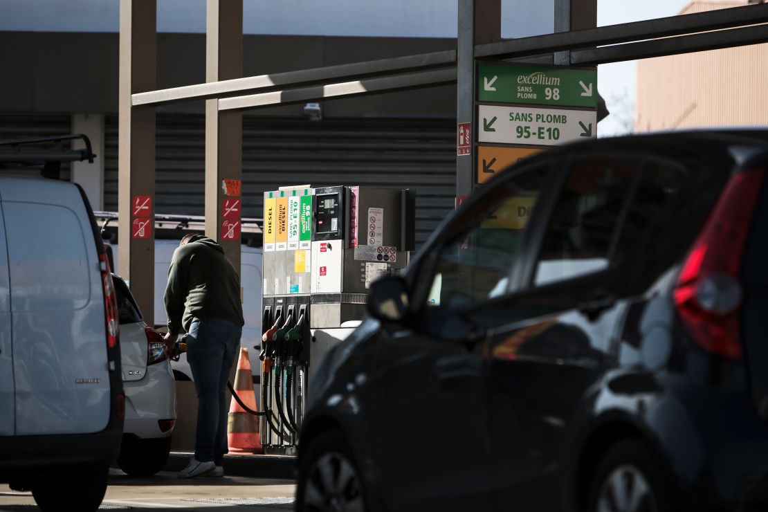 A customer refuels a vehicle at a TotalEnergies SE gas station in Toulouse, France, on Thursday, Feb. 10, 2022. TotalEnergies promised to increase its dividend and buy back more shares after posting a record fourth-quarter profit. 