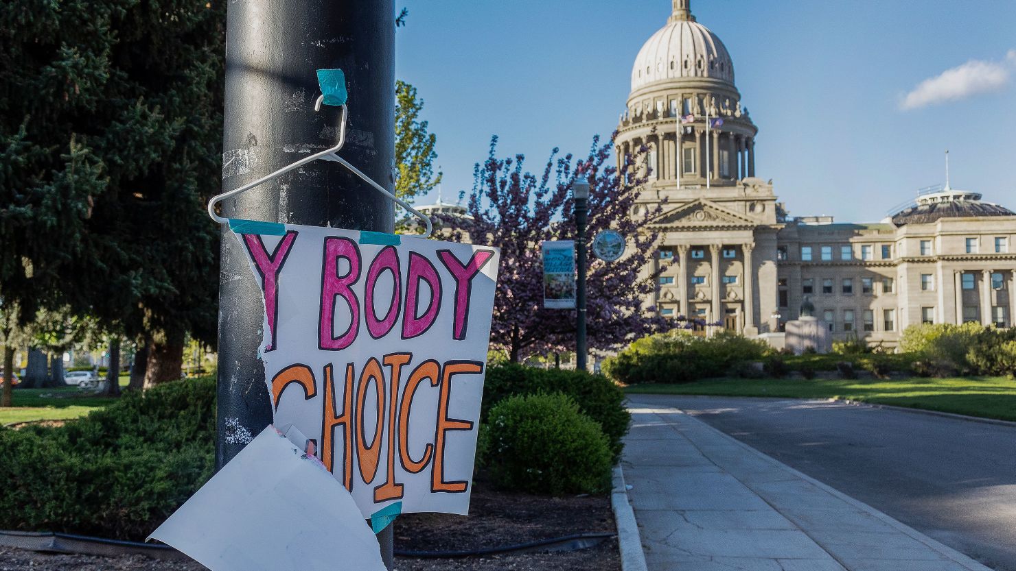 A sign reading "My body, my Choice," is taped to a hanger taped to a streetlight in front of the Idaho State Capitol Building on May 3, 2022. 