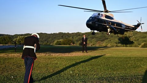 A US Marine braces against the wind as Marine One lands to pick up US President Joe Biden at Brandywine Creek State Park in Wilmington, Delaware on August 20, 2022.