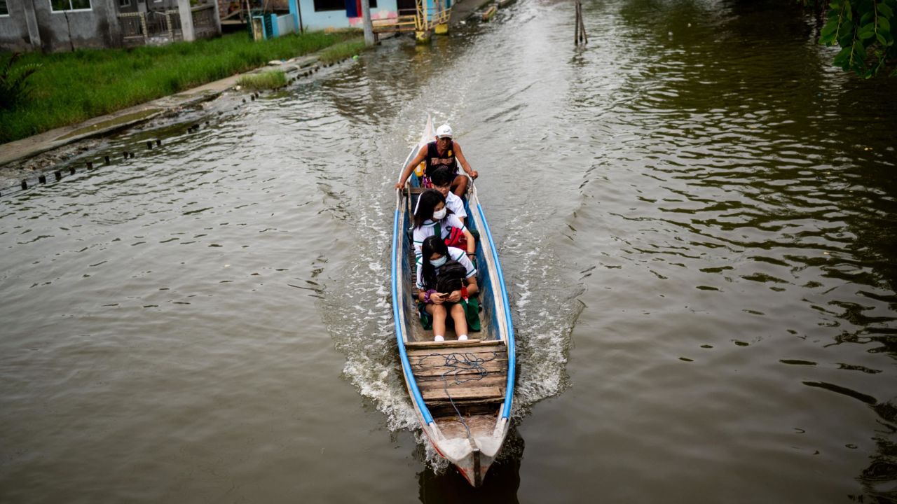 Students ride a boat to school during the first day of in-person classes, in Macabebe, Pampanga province, Philippines, August 22, 2022.