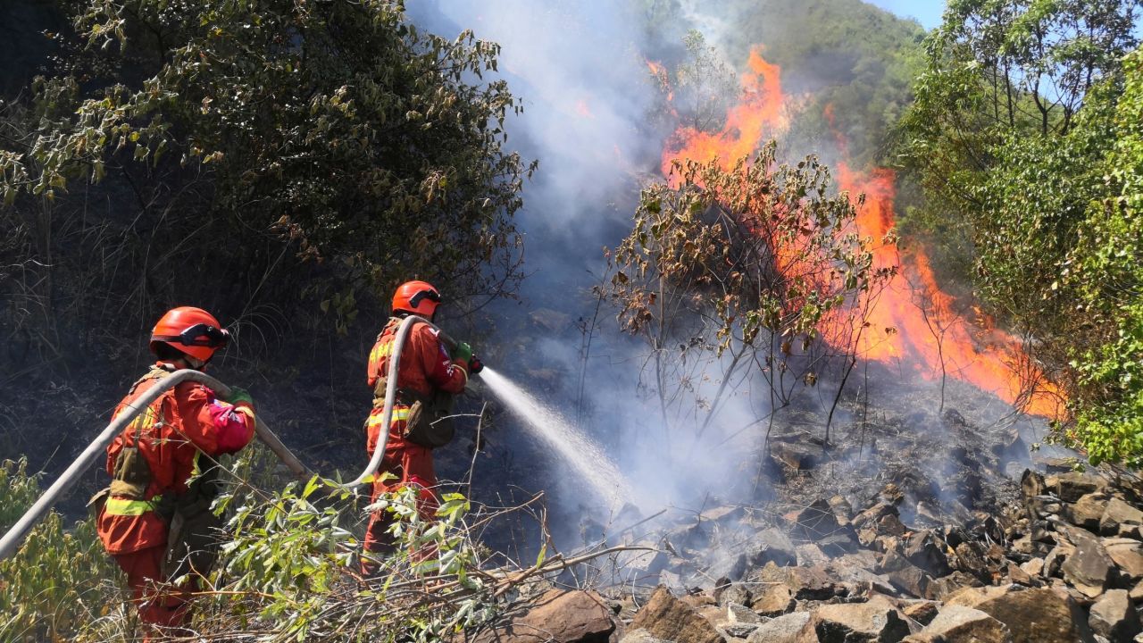 Firefighters combat a mountain wildfire in Chongqing, China on August 22.