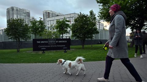 A woman walks her dog outside the US embassy in Kyiv on May 18, 2022.