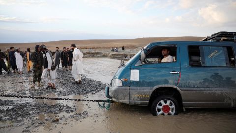 A minivan is towed out of floodwaters in the Khushi district of Logar, Afghanistan, August 21, 2022.