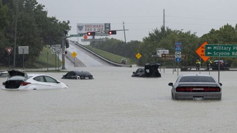 Stalled cars sit abandoned on the flooded Interstate 635 Service Road in Mesquite, Texas, on Monday.